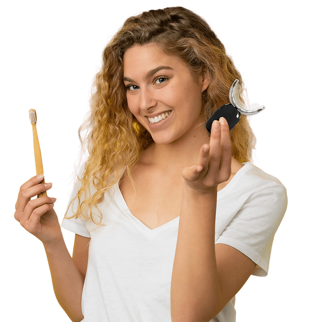 lady holding toothbrush and whitening kit 
